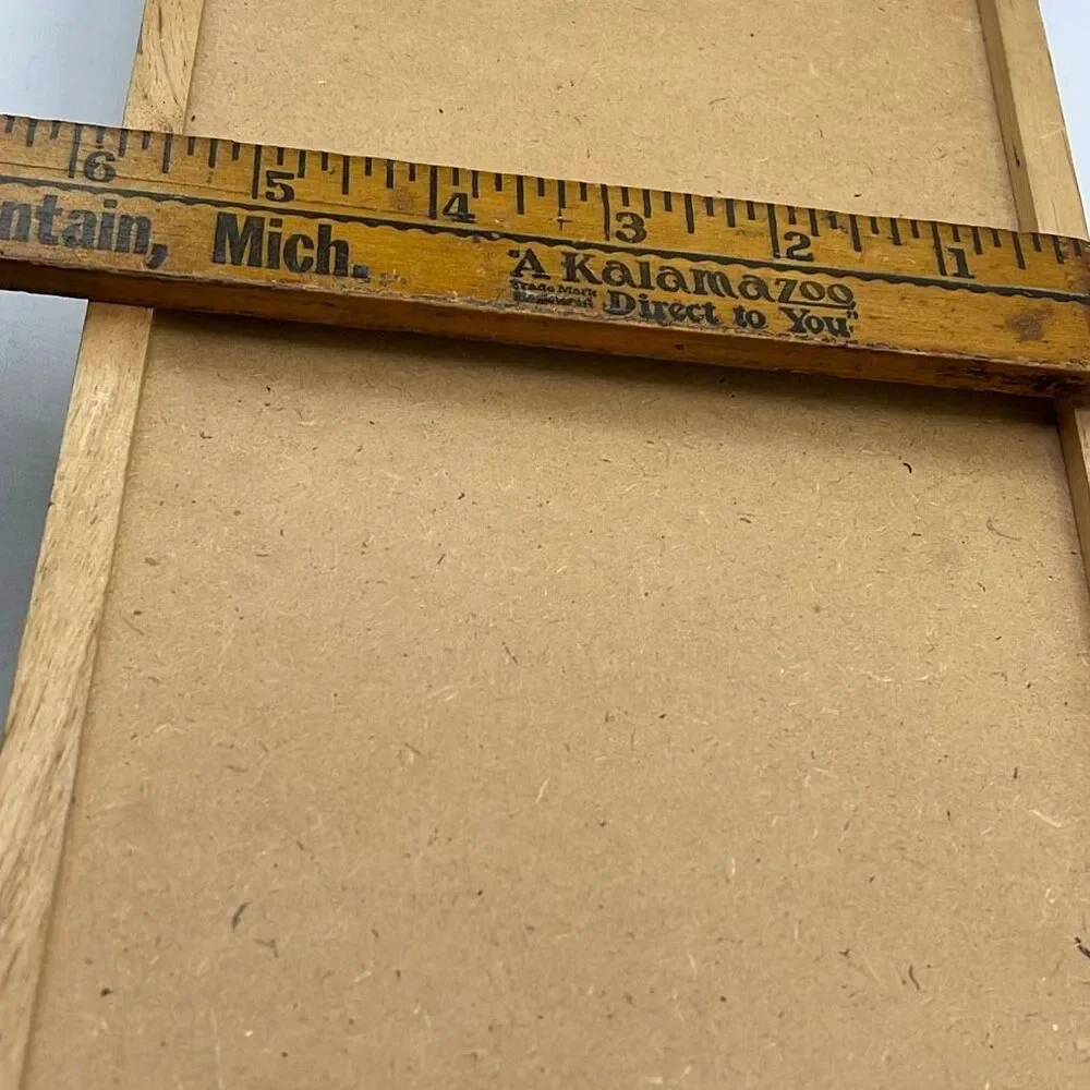 Vintage wooden wall organizer for keys and mail.